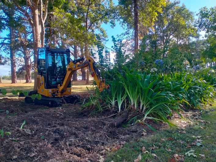 Photo of excavator cleaning yard